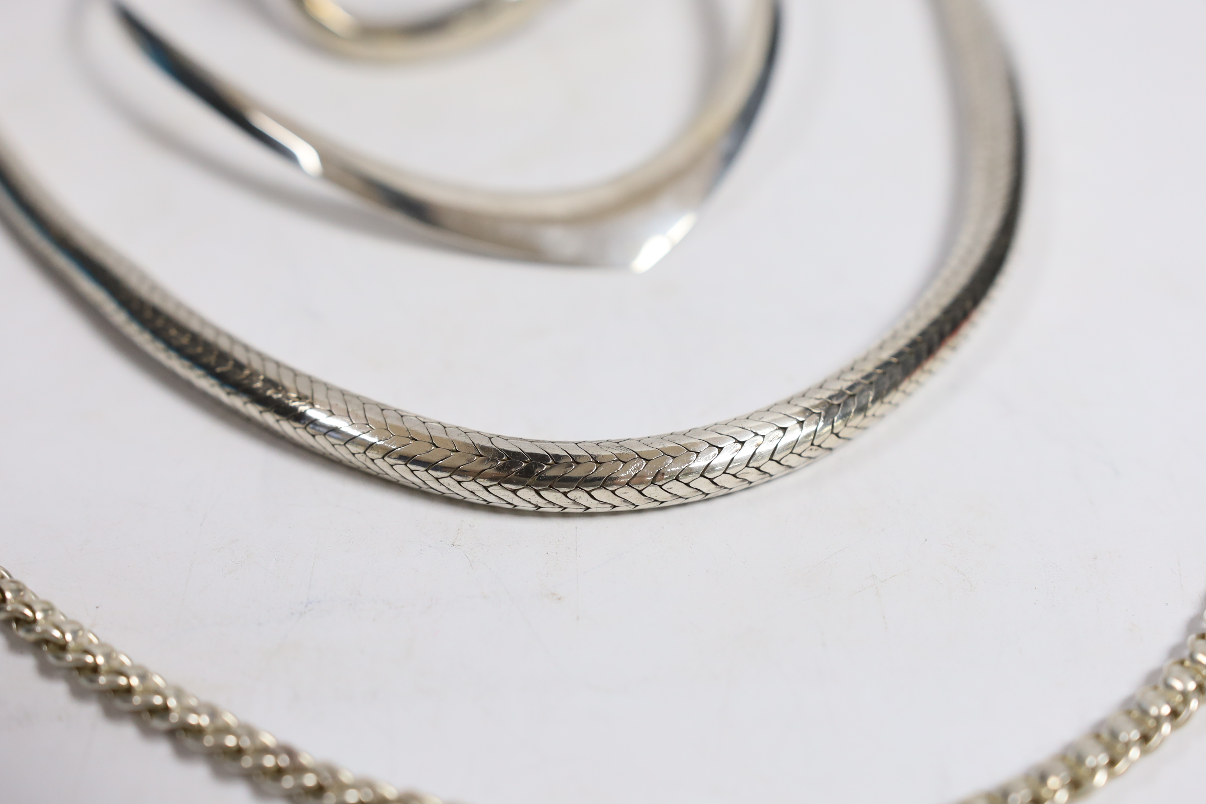 A large continental white metal snake link necklace, 44cm, a silver chain, a silver crossover bracelet and a 925 necklet.